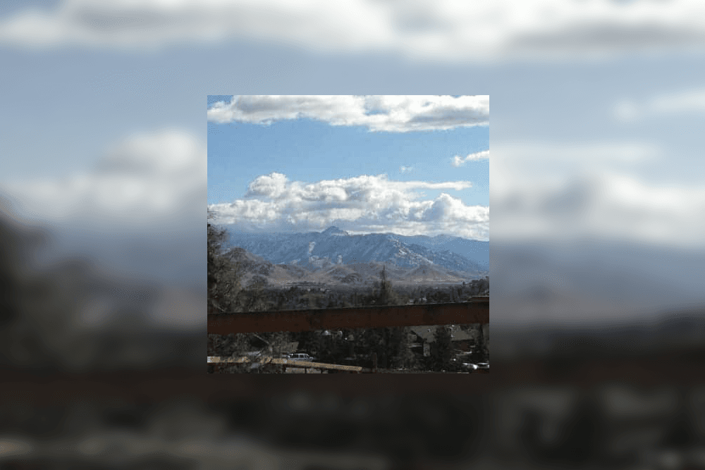 Scenic mountain landscape under a partly cloudy sky.